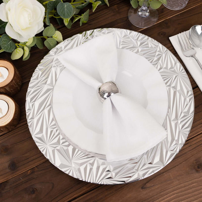 Elegant dinner plate set with silver accents and white napkin on a wooden table.