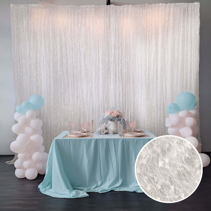 Elegant party backdrop with table setting and decorations in soft pastel colors.