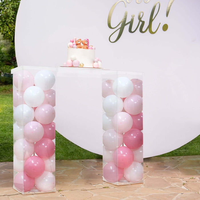 Clear balloon-filled table for a gender reveal party celebration.