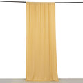 Yellow drapery fabric hanging in a studio setting