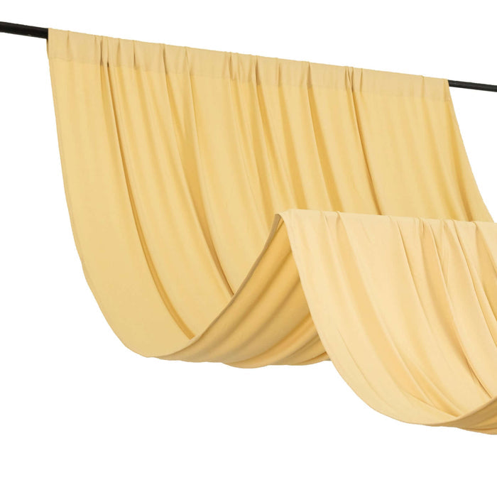 Yellow drapery fabric elegantly hanging on a rod.