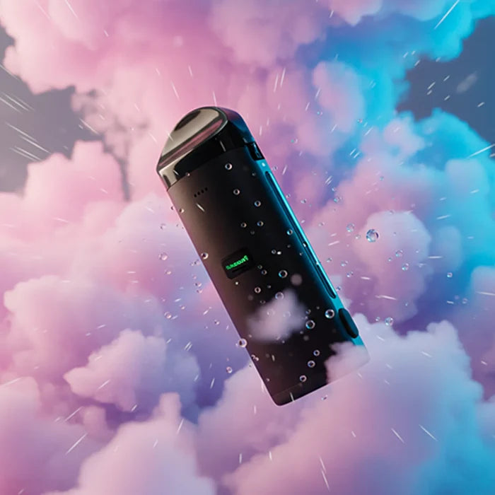 Angled close-up of the Cloudious 9 Atomic9 Dry Herb Vaporizer floating amid pink and blue cloud-like vapor with water droplets on its matte black body