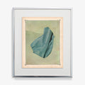 Abstract print with a teal draped fabric element against a light green background framed in silver