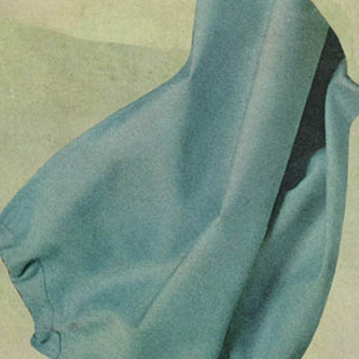 Close-up detail of an abstract print with light blue draped fabric on a muted green background