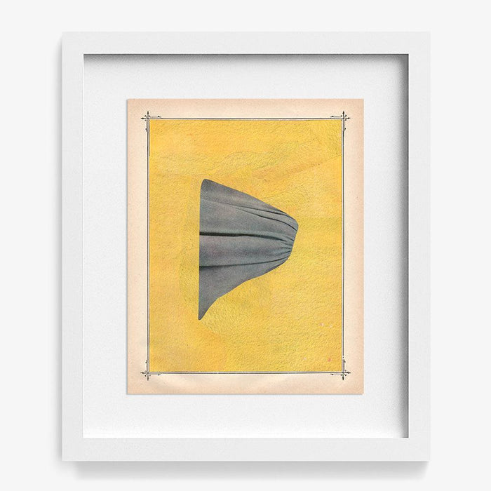 Abstract print with a grey folded fabric shape against a textured yellow background in a white frame
