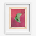 Abstract print with a green curved shape on a textured pink background framed in white wood