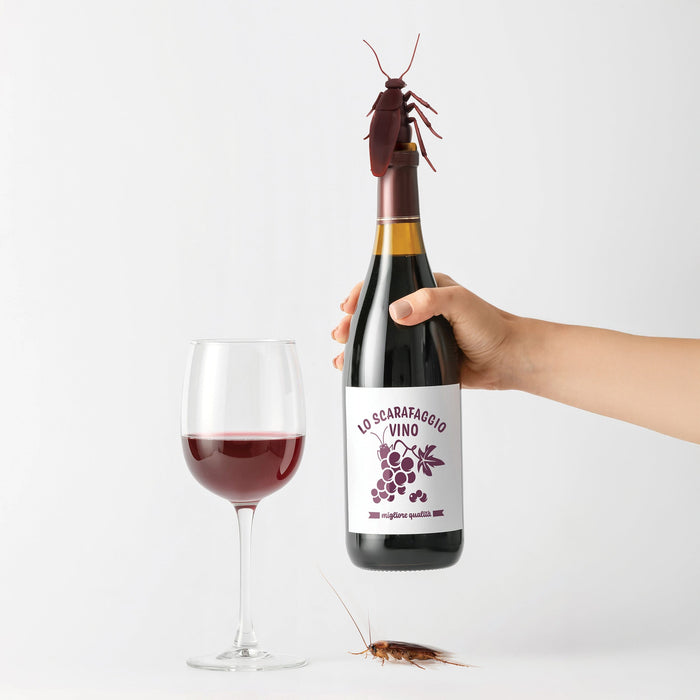 Bottle of 'Lo Scarafaggio Vino' wine with a hand holding it, a glass of wine, and a cockroach bottle stopper on a white background.
