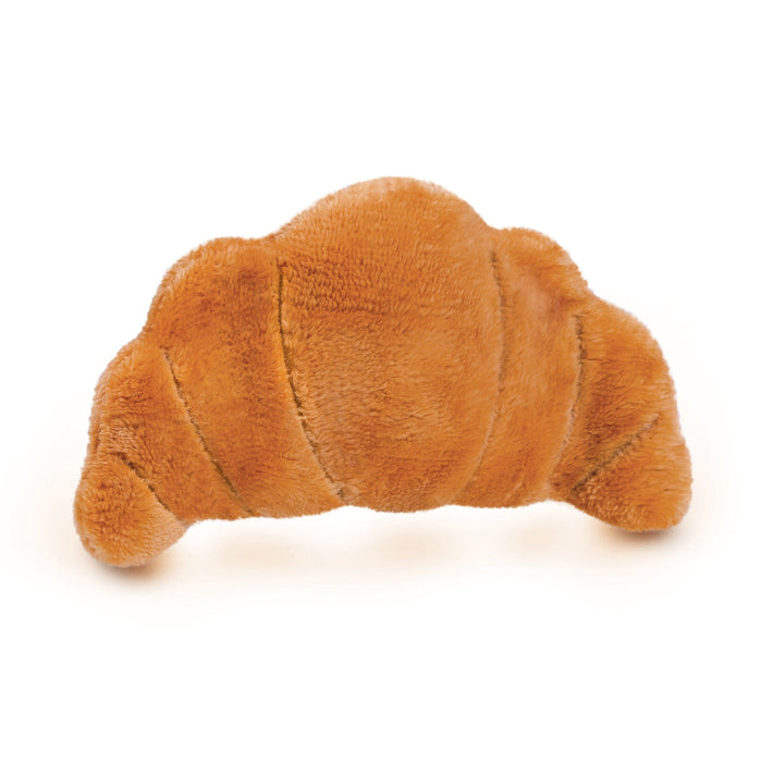 A plush eye pillow that looks like a croissant on a white background