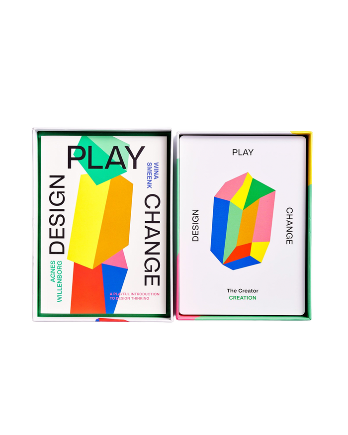 Two product boxes for 'Design Play' are shown side-by-side on a plain white background. The left box features a colorful geometric design with the text 'DESIGN PLAY CHANGE' and 'MORE WILDERNESS MORE DESIGN'.
