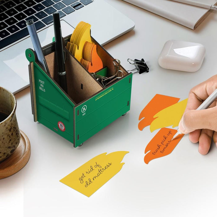 Mini green dumpster-fire desk organizer filled with fiery note cards and pencils — quirky office décor and Secret Santa gift.