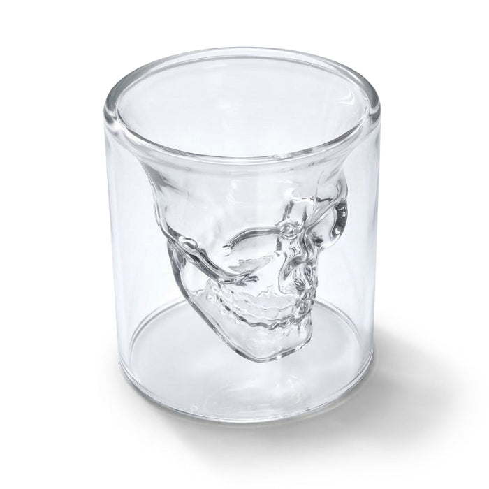 Clear glass skull-shaped shot glass on a white background