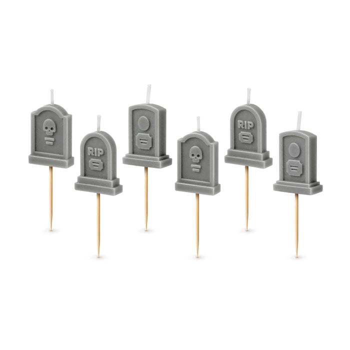 Set of six gray tombstone-shaped candles on sticks with 'RIP' text and skull designs.