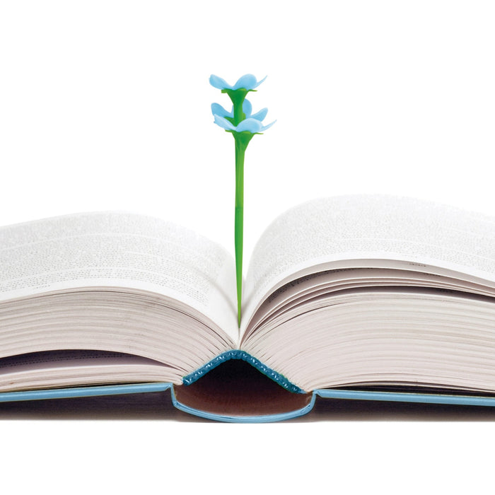 Open book with a 3D blue flower bookmark on a white background