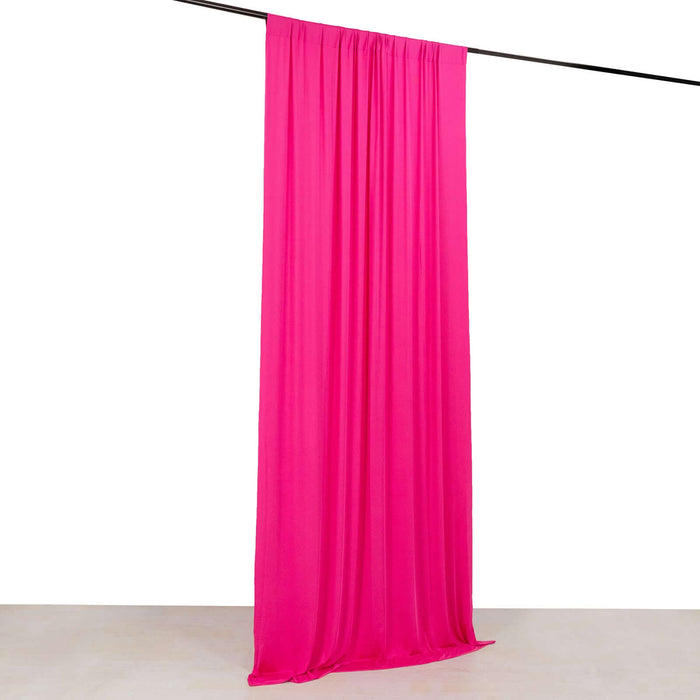 Bright pink fabric drape hanging from a rod on a white background.