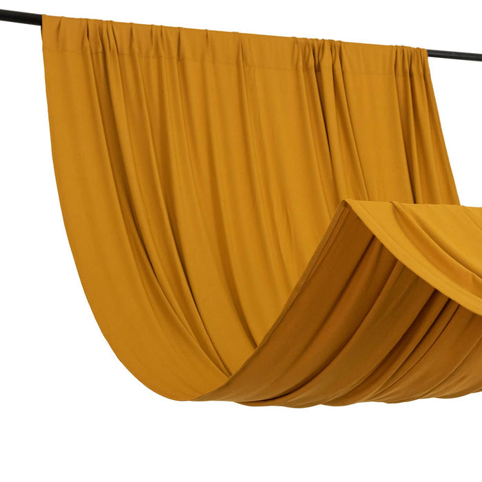 Mustard yellow fabric draped elegantly on a black rod