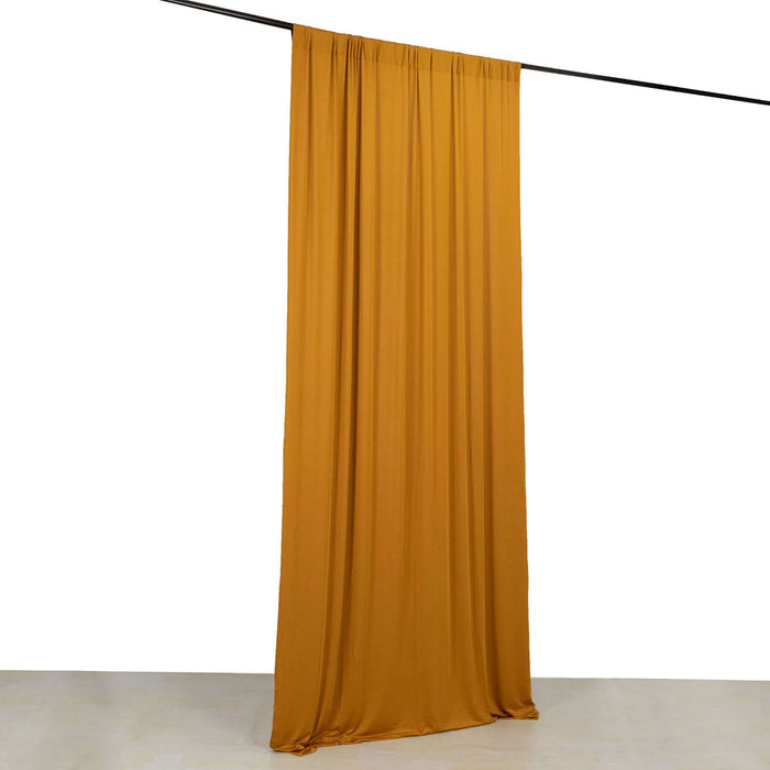Mustard yellow fabric drape hanging from a rod against a white background