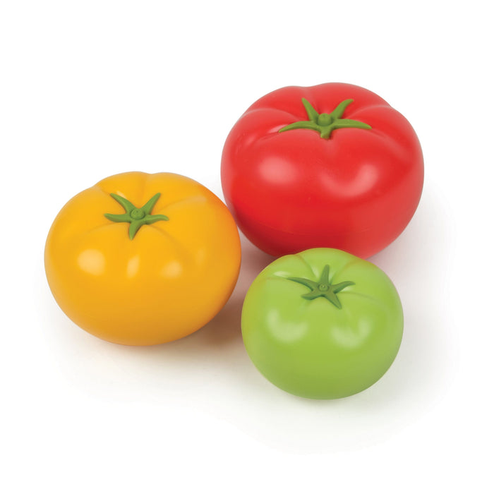 Set of colorful tomato-shaped measuring cups on a white background