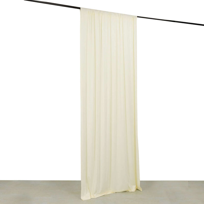 Cream sheer curtain hanging from a black rod on a white background