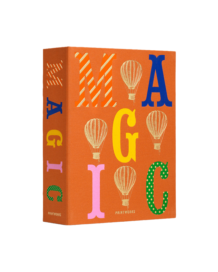 An orange hardcover book or box titled 'MAGIC' with colorful decorative letters and hot air balloon illustrations, shown on a plain white background.