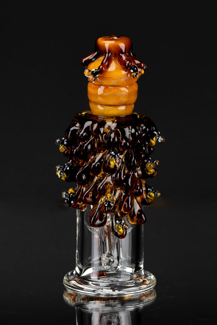 Close-up front view of the Mini Rig - Beehive Nano showing amber glass beehive detailing and drip-like dark amber ornamentation on a clear glass base