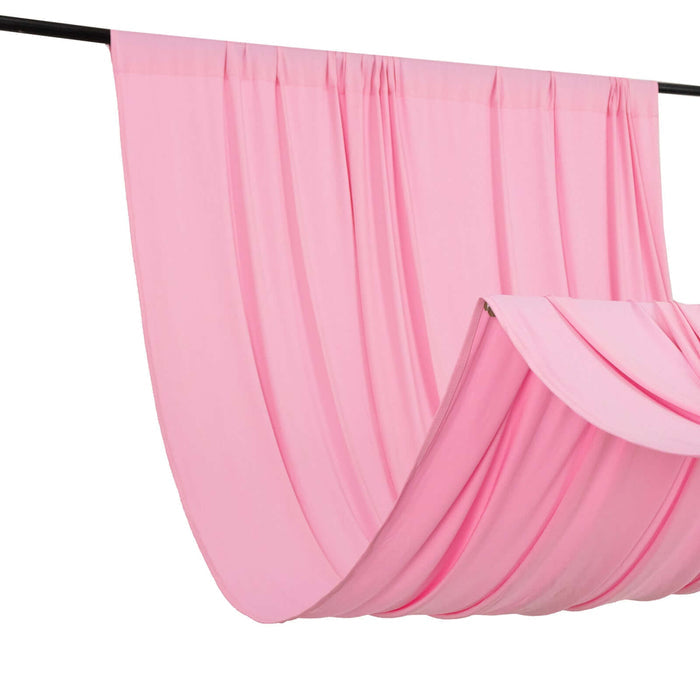 Pink fabric draped on a rod, showcasing soft texture and flow.