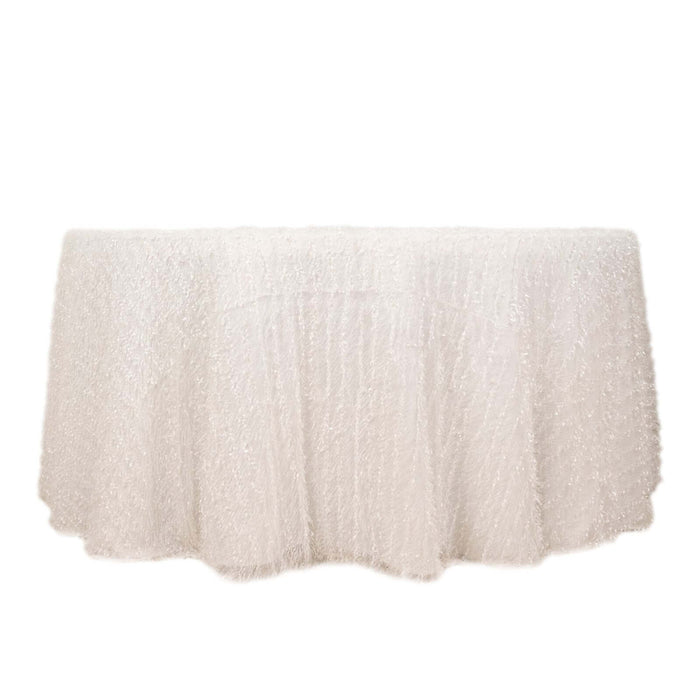 White fringed tablecloth on a plain backdrop.