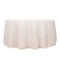 White fringed tablecloth on a plain backdrop.