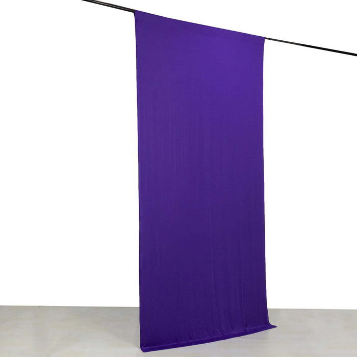 Purple fabric backdrop hanging on a rod for photography use.