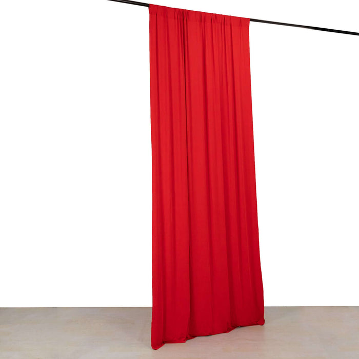 Red curtain hanging from a rod against a plain white background.