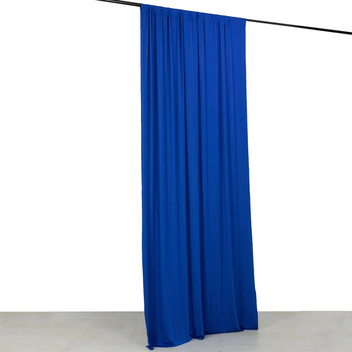 Blue fabric curtain draped on a rod against a plain white backdrop