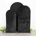 Set of three black velvet photo backdrops in various heights.