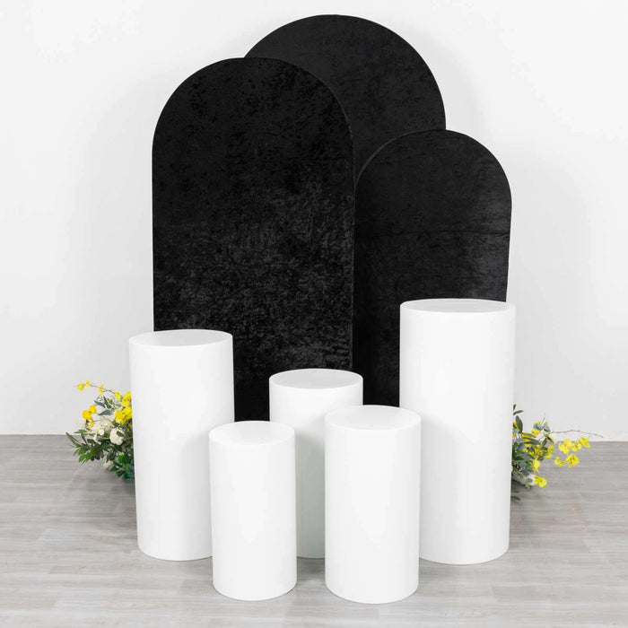Set of white and black display pedestals with floral accents