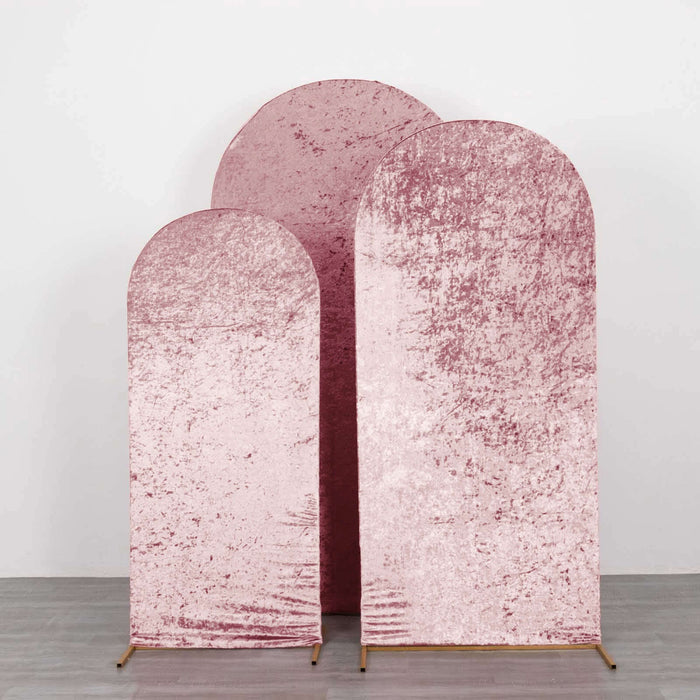 Three pink velvet backdrops in varying sizes on a plain background.