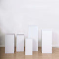 White display pedestals in various heights on a plain backdrop