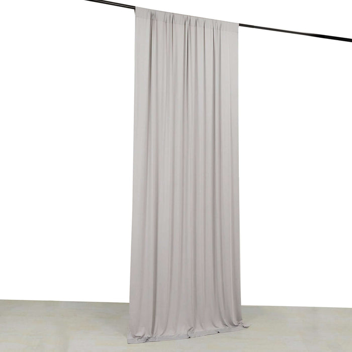 Gray fabric curtain draped on a rod
