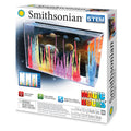 The Smithsonian Magic Rocks kit from Smithsonian features a space-themed box showing vibrant crystals growing in a tank, highlights "Grow Magic Rocks" and "Create a Colorful Underwater Garden," and is recommended for ages 10+.