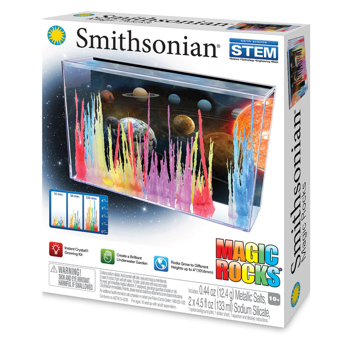 The Smithsonian Magic Rocks kit from Smithsonian features a space-themed box showing vibrant crystals growing in a tank, highlights "Grow Magic Rocks" and "Create a Colorful Underwater Garden," and is recommended for ages 10+.