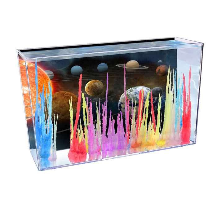 The Smithsonian Magic Rocks kit by Smithsonian features a clear box where colorful crystals—red, pink, blue, purple, yellow, and white—grow amidst an illustrated space backdrop with planets and stars for a fun STEM experiment.