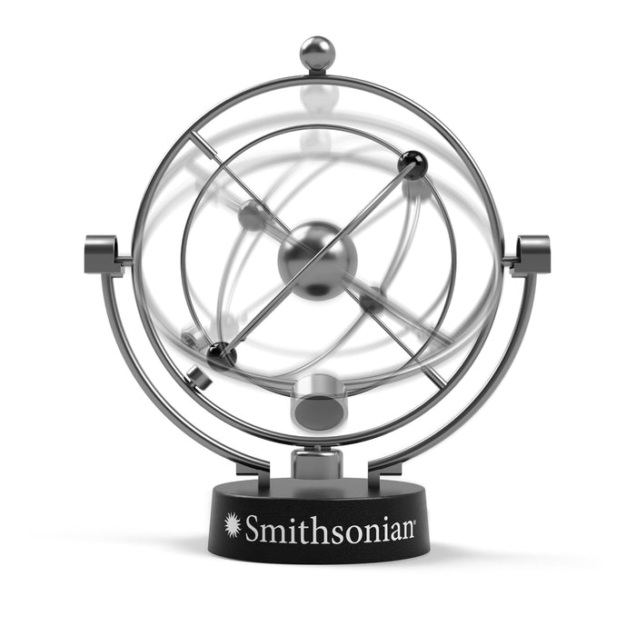 The Smithsonian Perpetual Motion Machine by Smithsonian is a kinetic display sculpture with spinning rings and spheres, evoking an atom in motion. Mounted on a black base, it’s a captivating STEM learning tool for any space.