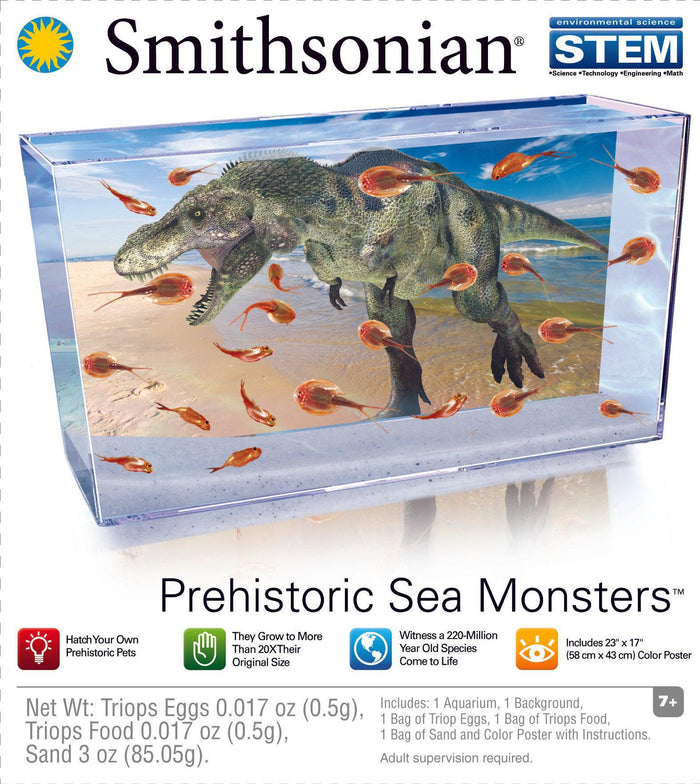 A clear aquarium toy STEM kit with a dinosaur model and Triops swimming inside, labeled "Smithsonian Prehistoric Sea Monsters" and featuring STEM branding and the Smithsonian logo.