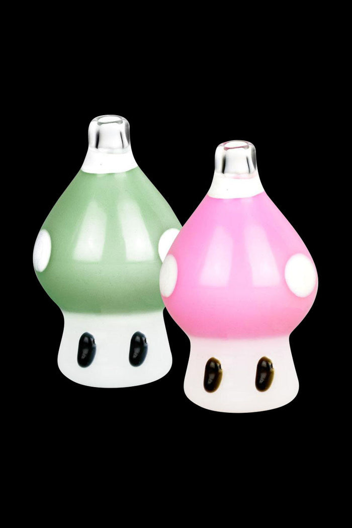 A close-up, angled view of the Magic Mushroom Bubble Carb Cap, showcasing its vibrant pink and green color scheme.