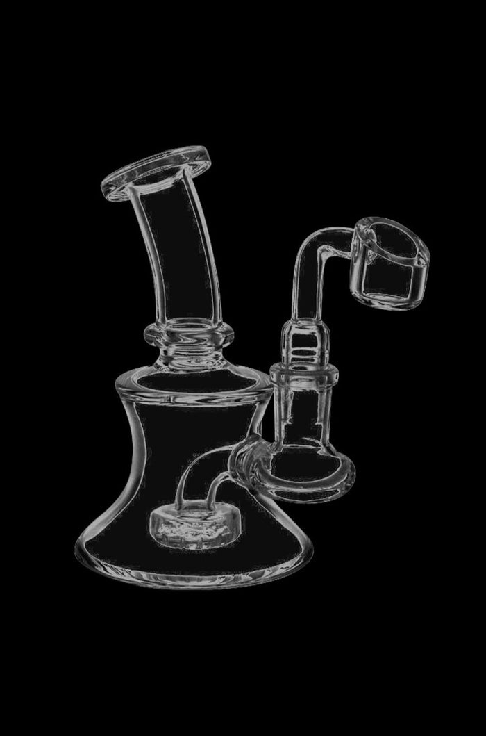 A studio shot of the Simple Scientific Mini Glass Oil Dab Rig with Banger, angled to showcase its compact size and clear glass construction.
