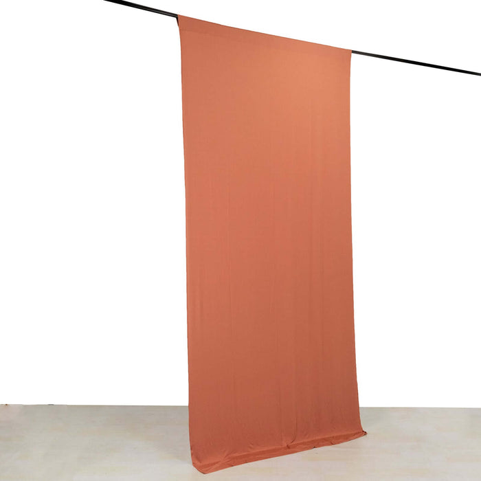 Orange fabric backdrop hanging in a studio setting