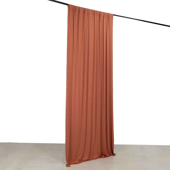 Rust-colored backdrop curtain draped elegantly on a support bar