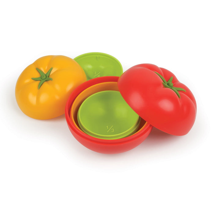 Set of colorful tomato-shaped measuring cups on a white background